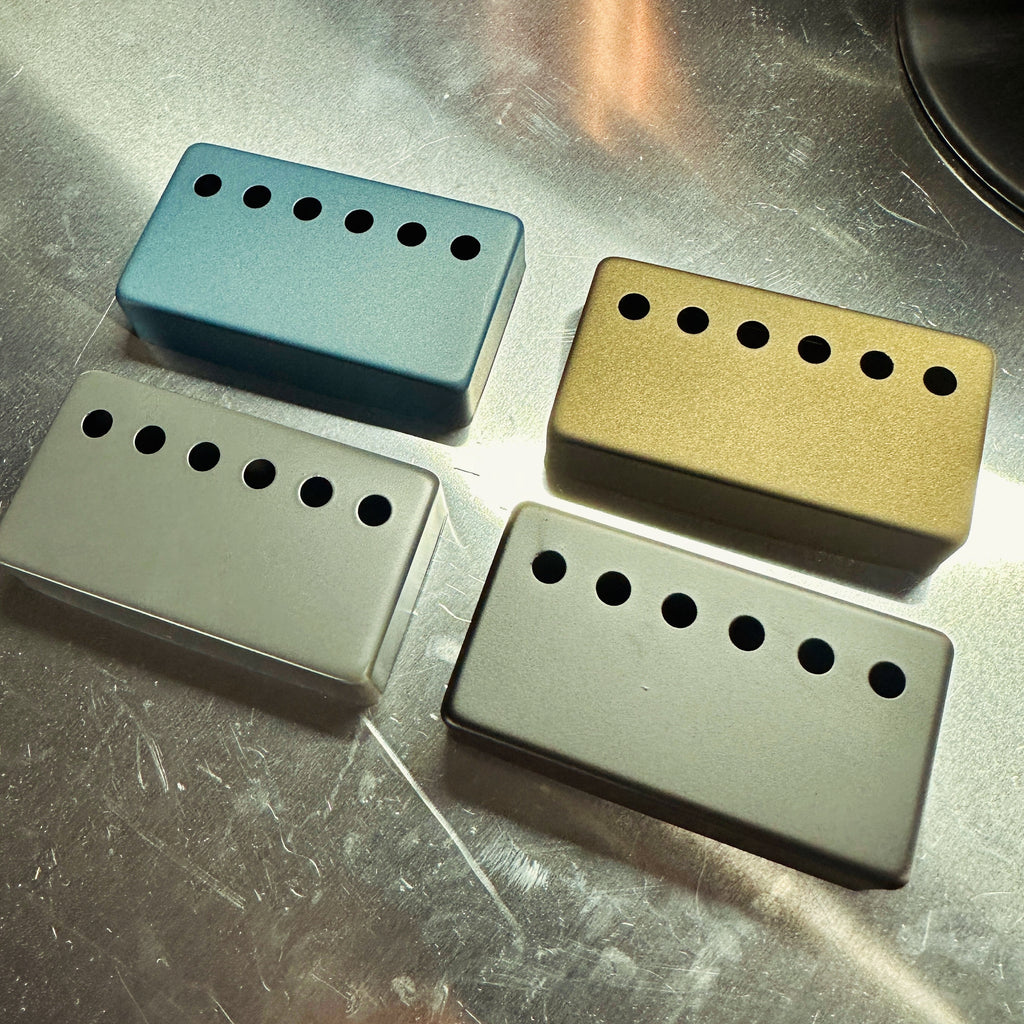 cerakote hum bucker pickup covers in denim, bronze, gray, and black