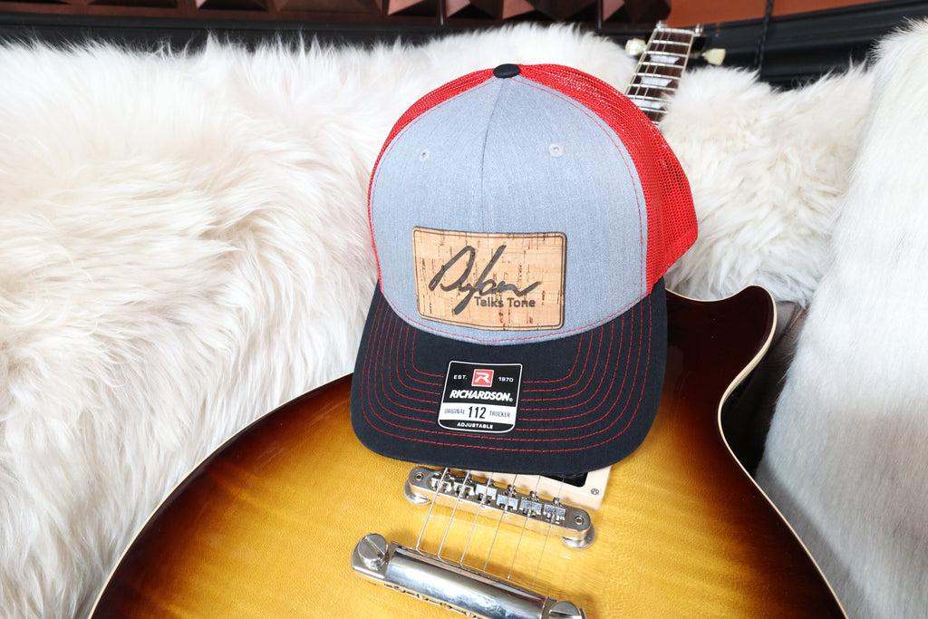 red and gray hat with cork patch with Dylan logo